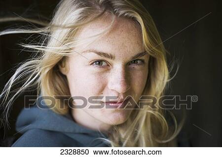 Stock Image - Portrait Of A Young Woman With Blond Hair; False Pass, Alaska, United States Of America. Fotosearch