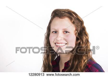 Stock Image - Portrait of a young woman with long, curly hair on a white background; Alberta, Canada. Fotosearch