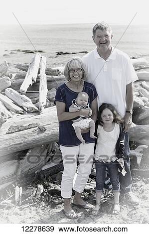 Stock Photo - Portrait of grandparents with their grandchildren on the beach at a family reunion; Whidbey Island, Washington, United States of America. Fotosearch