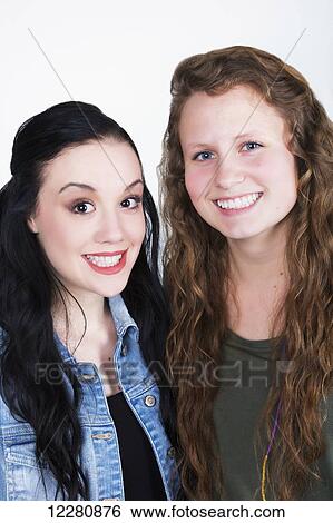 Portrait of two young women with exaggerated smiles; Alberta, Canada View Large Photo Image Stock Photograph - Portrait of two young women with exaggerated smiles; Alberta, Canada. Fotosearch