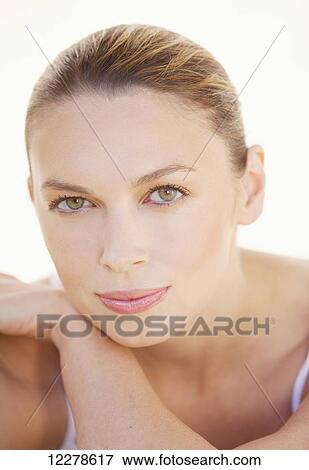 Portrait on a woman with hair pulled back on a white background; Hawaii, United States of America View Large Photo Image Stock Photo - Portrait on a woman with hair pulled back on a white background; Hawaii, United States of America. Fotosearch
