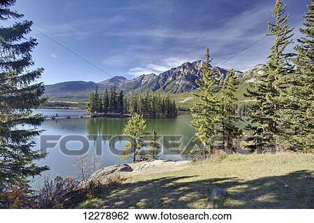 Stock Image - Pyramid Lake is kidney-shaped lake in Jasper National Park lying at the foot of Pyramid Mountain; Alberta, Canada. Fotosearch