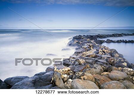Stock Photo - Rocks along the coast of Lydgate Beach Park; Lydgate, Kauai, Hawaii, United States of America. Fotosearch