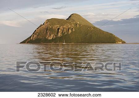 Stock Image - Sailboat In Front Of Amagat Island Between Morzhovoi Bay And Cold Bay On The Alaska Peninsula; Southwest Alaska, United States Of America. Fotosearch
