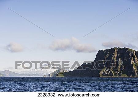 Shishaldin Volcano And Isanotski Peaks In The Background Of The Rugged Cliff Shoreline Of Cape Pankof On Unimak Island, Eastern Aleutian Islands; Southwestern Alaska, United States Of America View Large Photo Image Stock Image - Shishaldin Volcano And Isanotski Peaks In The Background Of The Rugged Cliff Shoreline Of Cape Pankof On Unimak Island, Eastern Aleutian Islands; Southwestern Alaska, United States Of America. Fotosearch