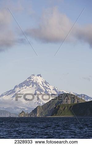 Shishaldin Volcano And Isanotski Peaks In The Background Of The Rugged Cliff Shoreline Of Cape Pankof On Unimak Island, Eastern Aleutian Islands; Southwestern Alaska, United States Of America View Large Photo Image Stock Image - Shishaldin Volcano And Isanotski Peaks In The Background Of The Rugged Cliff Shoreline Of Cape Pankof On Unimak Island, Eastern Aleutian Islands; Southwestern Alaska, United States Of America. Fotosearch