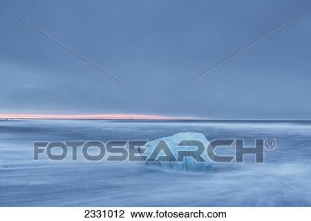 Small Iceberg By Itself With The Ocean Flowing Around It; Southern Iceland View Large Photo Image Stock Image - Small Iceberg By Itself With The Ocean Flowing Around It; Southern Iceland. Fotosearch