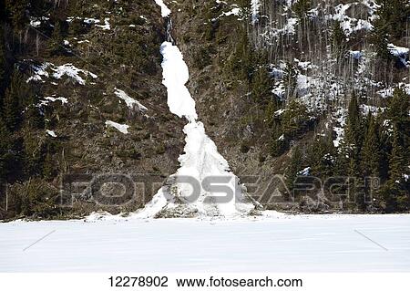 Stock Image - Small winter avalanche along the side of Duffy Lake, near Pemberton and Lillooet; British Columbia, Canada. Fotosearch