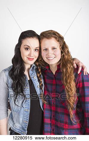 Studio portrait of two young women with their hair braided together; Alberta, Canada View Large Photo Image Stock Photography - Studio portrait of two young women with their hair braided together; Alberta, Canada. Fotosearch