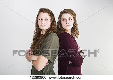 Studio shot of two girlfriends fighting, on a white background; Alberta, Canada View Large Photo Image Stock Image - Studio shot of two girlfriends fighting, on a white background; Alberta, Canada. Fotosearch