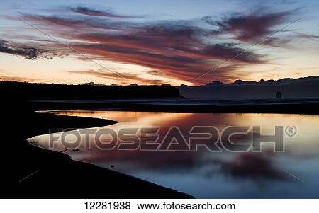 Stock Photo - Sunset at Rapahoe beach on the West Coast; South Island, New Zealand. Fotosearch