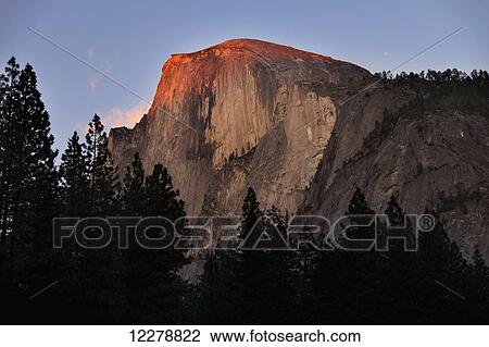 Stock Image - Sunset on Half Dome as seen from Yosemite Valley, Yosemite National Park; California, United States of America. Fotosearch
