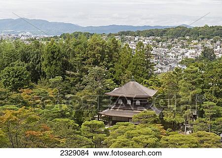Picture - Temple Surrounded By Trees With The City In The Background; Kyoto, Japan. Fotosearch