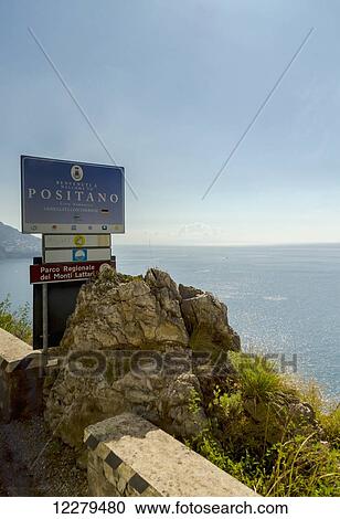 Stock Image - The Amalfi Coast drive highway sign indicating the entrance to the popular village of Positano; Positano, Campania, Italy. Fotosearch