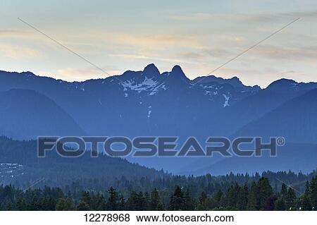 Stock Photo - The Lions, famous peaks in the North Shore Mountains; British Columbia, Canada. Fotosearch