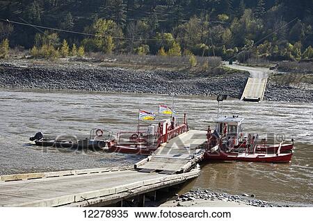 Stock Photography - The Lytton cable ferry crossing the Fraser River, North of Lytton; British Columbia, Canada. Fotosearch