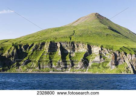 The Pallisade Cliffs In Ikatan Bay Of False Pass, Also Known As Isanotski Strait, In Summertime; Southwest Alaska, United States Of America View Large Photo Image Stock Image - The Pallisade Cliffs In Ikatan Bay Of False Pass, Also Known As Isanotski Strait, In Summertime; Southwest Alaska, United States Of America. Fotosearch