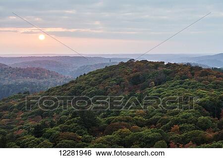 The sun setting over endless autumn coloured forests of Algonquin Highlands; Ontario, Canada View Large Photo Image Stock Photograph - The sun setting over endless autumn coloured forests of Algonquin Highlands; Ontario, Canada. Fotosearch