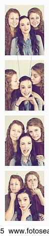 Stock Photography - Three young women creating photo booth series of images in filmstrip format; Alberta, Canada. Fotosearch
