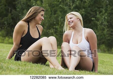 Two girlfriends spending quality time together in a park; Edmonton, Alberta, Canada View Large Photo Image Stock Photography - Two girlfriends spending quality time together in a park; Edmonton, Alberta, Canada. Fotosearch