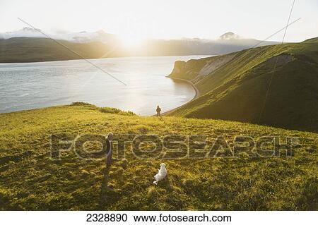 Two Girls Walk Their Dog Through The Muskeg On The Bluff Above Their Family's Fish Camp; False Pass, Alaska, United States Of America View Large Photo Image Stock Image - Two Girls Walk Their Dog Through The Muskeg On The Bluff Above Their Family's Fish Camp; False Pass, Alaska, United States Of America. Fotosearch