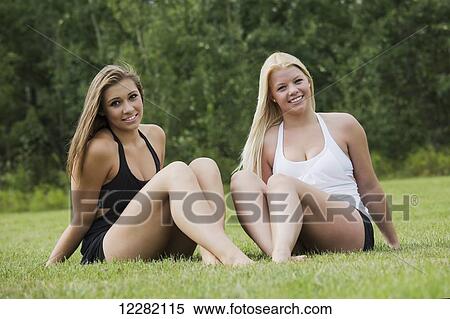 Two teenage girlfriends spending quality time together in a park; Edmonton, Alberta, Canada View Large Photo Image Stock Photography - Two teenage girlfriends spending quality time together in a park; Edmonton, Alberta, Canada. Fotosearch