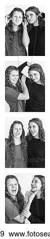Stock Photo - Two young women creating photo booth series of images in filmstrip format; Alberta, Canada. Fotosearch