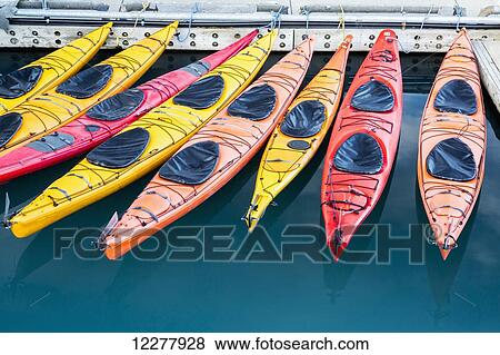Stock Photo - View of colorful kayaks tied to the harbor dock in Valdez, Southcentral Alaska, Summer. Fotosearch