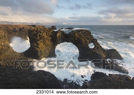 Waves Crash Through A Natural Archway Near Arnarstapi On The Snaefellsnes Peninsula; Iceland View Large Photo Image Picture - Waves Crash Through A Natural Archway Near Arnarstapi On The Snaefellsnes Peninsula; Iceland. Fotosearch