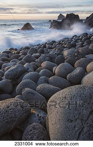 Picture - Waves Crashing Against The Shoreline And The Rounded Rocks Along The Southwestern Coast Of The Reykjanes Peninsula; Iceland. Fotosearch