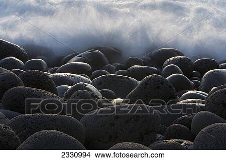 Picture - Waves Crashing Over Round Rocks On The Southwestern Coast Of Iceland; Iceland. Fotosearch