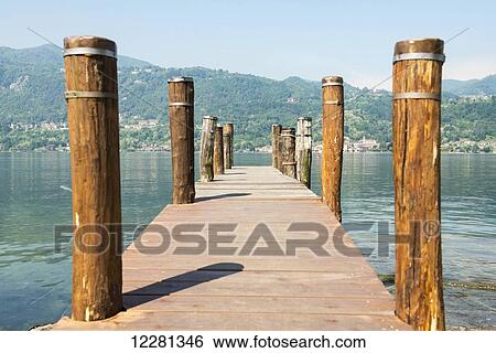 Wooden dock and posts on Lake Orta; Orta, Piedmont, Italy View Large Photo Image Stock Photograph - Wooden dock and posts on Lake Orta; Orta, Piedmont, Italy. Fotosearch