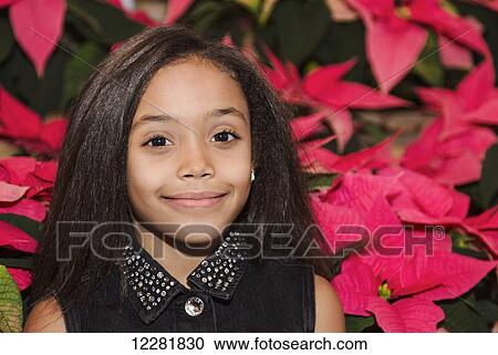 Young girl posing in front of poinsettia plants in a shopping centre; St. Albert, Alberta, Canada View Large Photo Image Stock Image - Young girl posing in front of poinsettia plants in a shopping centre; St. Albert, Alberta, Canada. Fotosearch