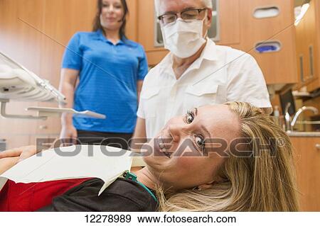 Stock Photo - Young woman at a dental appointment; Edmonton, Alberta, Canada. Fotosearch