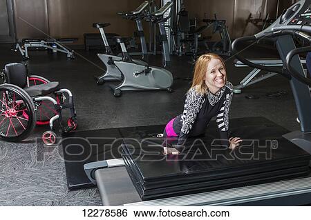 Young woman with spinal cord injury resting after workout routine; Edmonton, Alberta, Canada View Large Photo Image Stock Photograph - Young woman with spinal cord injury resting after workout routine; Edmonton, Alberta, Canada. Fotosearch