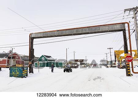 A Barrow resident on an ATV stops at a above ground utilities bridge, Barrow, North Slope, Arctic Alaska, USA, Winter View Large Photo Image Picture - A Barrow resident on an ATV stops at a above ground utilities bridge, Barrow, North Slope, Arctic Alaska, USA, Winter. Fotosearch