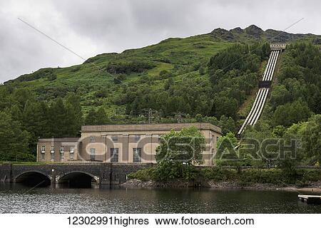 A building on the edge of the lake and pipes going up the hillside; Arrochar, Argyll and Bute, Scotland View Large Photo Image Stock Photograph - A building on the edge of the lake and pipes going up the hillside; Arrochar, Argyll and Bute, Scotland. Fotosearch