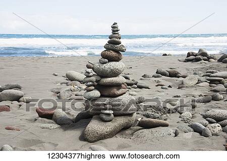 A cairn of stones is beautifully arranged on the beach; Island of Hawaii, Hawaii, United States of America View Large Photo Image Stock Photograph - A cairn of stones is beautifully arranged on the beach; Island of Hawaii, Hawaii, United States of America. Fotosearch