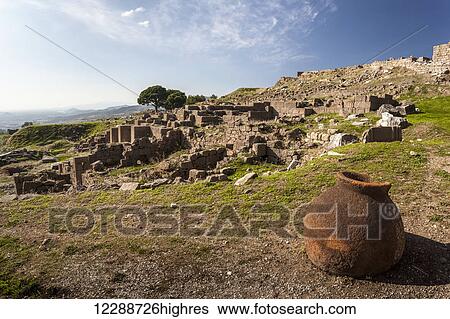 Stock Photograph - A clay water pot sits at the site of ancient ruins; Pergamum, Turkey. Fotosearch