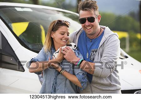 Stock Photograph - A couple holding a bunny rabbit; Cesky Krumlov, Czech Republic. Fotosearch