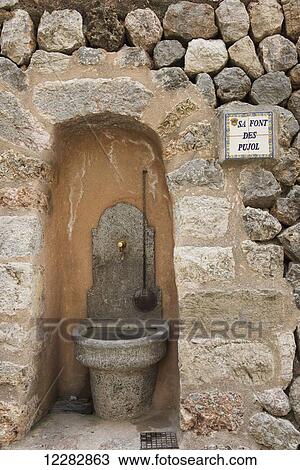 Stock Image - A drinking rest stop for walkers on the path to Soller; Mallorca. Fotosearch