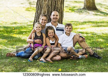 A family posing for a family portrait in a park; Edmonton, Alberta, Canada View Large Photo Image Stock Photograph - A family posing for a family portrait in a park; Edmonton, Alberta, Canada. Fotosearch