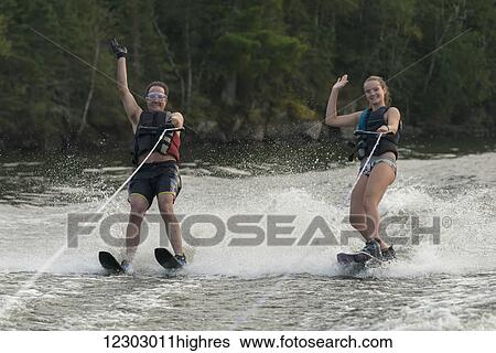 A father and daughter waterskiing side by side while waving to the camera; Ontario, Canada View Large Photo Image Stock Photograph - A father and daughter waterskiing side by side while waving to the camera; Ontario, Canada. Fotosearch