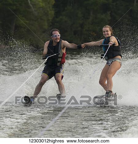 A father and daughter waterskiing side by side while fist bumping; Ontario, Canada View Large Photo Image Stock Photograph - A father and daughter waterskiing side by side while fist bumping; Ontario, Canada. Fotosearch