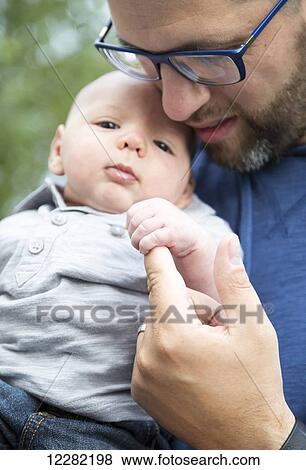 Stock Photo - A father with his infant son; Chilliwack, British Columbia, Canada. Fotosearch