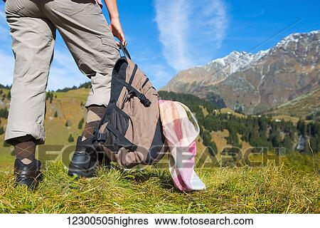Stock Photograph - A female hiker in the swiss alps; San Bernardino, Grisons, Switzerland. Fotosearch