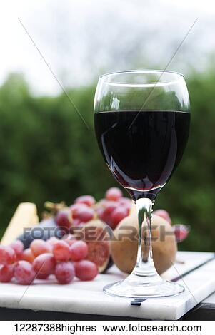 A glass of red wine with a fruit platter; Laval, Quebec, Canada View Large Photo Image Stock Photograph - A glass of red wine with a fruit platter; Laval, Quebec, Canada. Fotosearch