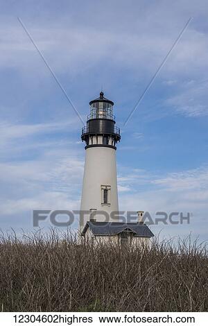 Stock Photograph - A handsome lighthouse is found at Yaquina Head on the Oregon Coast; Oregon, United States of America. Fotosearch
