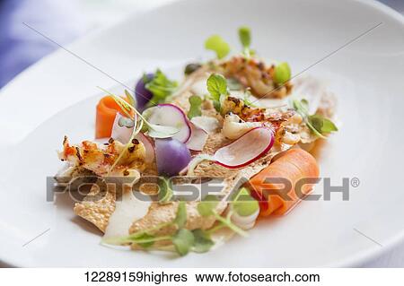 Stock Photograph - A healthy prepared fine dining fresh salad of greens, root vegetables and colorful vegetables nicely arranged on a plate and ready for service; Sooke, British Columbia, Canada. Fotosearch