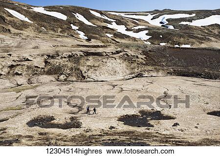 Stock Photograph - A hike through the Reykjadalur valley through thermal steam vents and boiling hot pools suitable for bathing; Reykjadalur, Iceland. Fotosearch